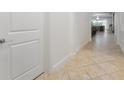 Bright hallway with tile flooring and modern door at 10824 Royal Cypress Way, Orlando, FL 32836