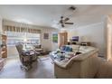 Living room with a curved sofa and ceiling fan at 15941 Sw 8Th Pl, Ocala, FL 34481