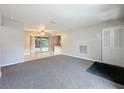 Bright living room with grey carpet and sliding glass doors at 1729 Vivian Ct, Deltona, FL 32725