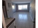 Bright living room featuring tile floors and large window at 1902 Honour Rd # 9, Orlando, FL 32839