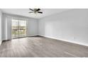Bright, airy bedroom with vinyl flooring, ceiling fan, neutral walls, and balcony access at 1932 Lake Atriums Cir # 69, Orlando, FL 32839