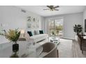Living room featuring modern decor, ceiling fan, outdoor access, stylish furniture, and neutral color palette at 1932 Lake Atriums Cir # 69, Orlando, FL 32839