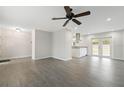 Open concept living area with wood-look floors and a view into the updated kitchen at 2123 Geigel Ct, Orlando, FL 32806