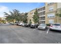 Condo building with parking lot and surrounding trees at 3362 Robert Trent Jones Dr # 30307, Orlando, FL 32835
