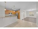 Kitchen with island, stainless steel appliances, and wood cabinets at 3362 Robert Trent Jones Dr # 30307, Orlando, FL 32835