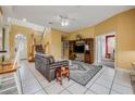 Spacious living room with tile floors, comfortable seating, and a large TV at 412 Vista Dr, Davenport, FL 33897