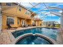 Inviting backyard oasis featuring a screened-in pool and spa at 412 Vista Dr, Davenport, FL 33897