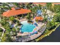 Resort-style pool with expansive deck and lake view at 4732 Vero Beach Pl, Kissimmee, FL 34746