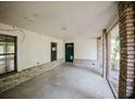 An enclosed porch featuring brick columns and accents, offering both style and protection from the elements at 585 Gasline Rd, Deland, FL 32724