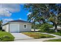 Newly built house featuring a carport and well-manicured lawn at 6120 Denson Dr, Orlando, FL 32808