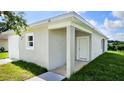 New construction home showcasing a side entrance and landscaping at 6120 Denson Dr, Orlando, FL 32808