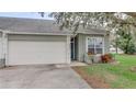 Attractive house exterior with a garage and neatly landscaped front yard at 654 Harbor Villa Ct, Clermont, FL 34711