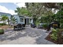 Private backyard patio with seating area, dining table, and shed at 801 E 8Th Ave, New Smyrna Beach, FL 32169