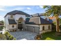 Two-story house featuring a large driveway and a lush green lawn at 8010 Firenze Blvd, Orlando, FL 32836