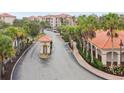 Gated community entrance with guardhouse and lush landscaping at 8010 Tuscany Way # 5302, Davenport, FL 33896