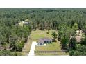 House nestled in a wooded area with a large lot and fenced yard at 13024 Sw 60Th Lane Rd, Ocala, FL 34481