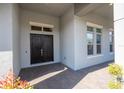 Front entrance with double doors and a brick walkway at 13370 Alderley Dr, Orlando, FL 32832