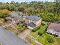 Two-story house with a large backyard, driveway and white fence at 13832 Riverpath Grove Dr, Orlando, FL 32826