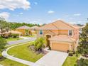 Two-story house with a large yard and a two-car garage at 2501 Dharma Cir, Kissimmee, FL 34746