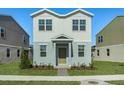 Two-story house with white and light gray siding, landscaping, and a paved walkway at 368 Belmond Dr, Debary, FL 32713