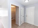 Bright foyer showcasing a white front door and access to laundry room at 512 Holbrook Cir, Lake Mary, FL 32746