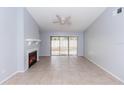 Cozy living room featuring tile floors, a modern fireplace, and sliding glass doors to the outside at 512 Holbrook Cir, Lake Mary, FL 32746