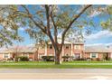 Brick building exterior with landscaping and a tree in front at 5824 La Costa Dr, Orlando, FL 32807