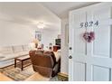 Living room with light colored sofa and recliner at 5824 La Costa Dr, Orlando, FL 32807