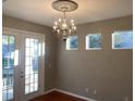 Bright dining room features a chandelier and French doors at 6344 Earthgold Dr, Windermere, FL 34786