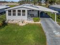 Single-wide manufactured home with carport and large yard at 6375 Lolly Bay Ne Loop, Winter Haven, FL 33881