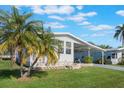 Single-wide manufactured home with carport and palm tree at 6375 Lolly Bay Ne Loop, Winter Haven, FL 33881