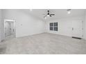 Bright and airy living room with tile flooring and a ceiling fan at 6455 Hemlock Rd, Ocala, FL 34472