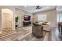 Spacious living room with stone wall and hardwood floors at 7400 Soiree Way, Reunion, FL 34747