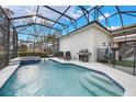 Relaxing pool area with a covered patio and grill at 7400 Soiree Way, Reunion, FL 34747