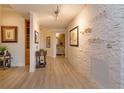 Elegant hallway with stone accent wall and hardwood floors at 100 S Eola Dr # 1401, Orlando, FL 32801