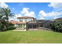 Large backyard with a pool and screened enclosure at 13412 Heswall Run, Orlando, FL 32832