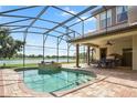 Spacious pool and patio area with outdoor kitchen and lake view at 13412 Heswall Run, Orlando, FL 32832
