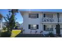 Side view of a two-story building with green accents and landscaping at 1750 S Palmetto Ave # 300, Daytona Beach, FL 32119