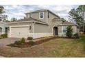 Two-story house with gray siding, a two-car garage, and landscaping at 223 Cherokee Hill, Deland, FL 32724