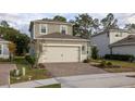 Two-story house with gray siding, a two-car garage, and landscaping at 223 Cherokee Hill, Deland, FL 32724
