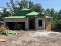 New construction home showing modern architectural design and block construction, garage, and green roof sheathing at 25122 Ensley Rd, Sorrento, FL 32776