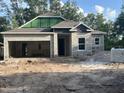 New home under construction features a spacious garage and modern window design at 25122 Ensley Rd, Sorrento, FL 32776