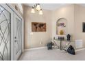 Entryway with glass doors, console table, and wall decor at 33931 Terragona Dr, Sorrento, FL 32776