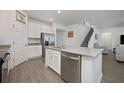 Modern kitchen with white cabinets, stainless steel appliances and island at 3439 Feathergrass Ct, Harmony, FL 34773