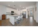 Spacious kitchen with white cabinets, stainless steel appliances, and an island at 3439 Feathergrass Ct, Harmony, FL 34773
