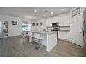 Kitchen features white cabinets, an island, and stainless steel appliances at 3439 Feathergrass Ct, Harmony, FL 34773