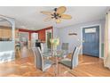 Bright dining area with a glass table, modern chairs, and an open view into the kitchen, creating an inviting and functional space at 5607 Huber Dr, Orlando, FL 32818