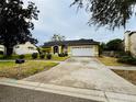 House exterior showcasing a driveway and landscaping at 567 Rachael Court, Oviedo, FL 32765