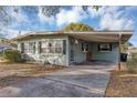 House with carport, mature trees, and a spacious yard at 637 19Th St, Orlando, FL 32805