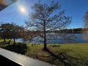 Sunny lake view from condo balcony, featuring a large tree at 912 Lake Destiny Rd # G, Altamonte Springs, FL 32714